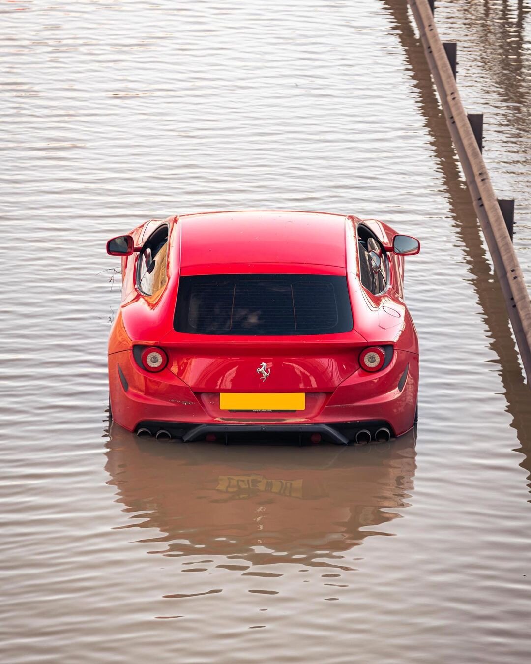 A red Ferrari FF submerged in approximately 1.6 feet of flood water in  London | AutomobiliFerrari