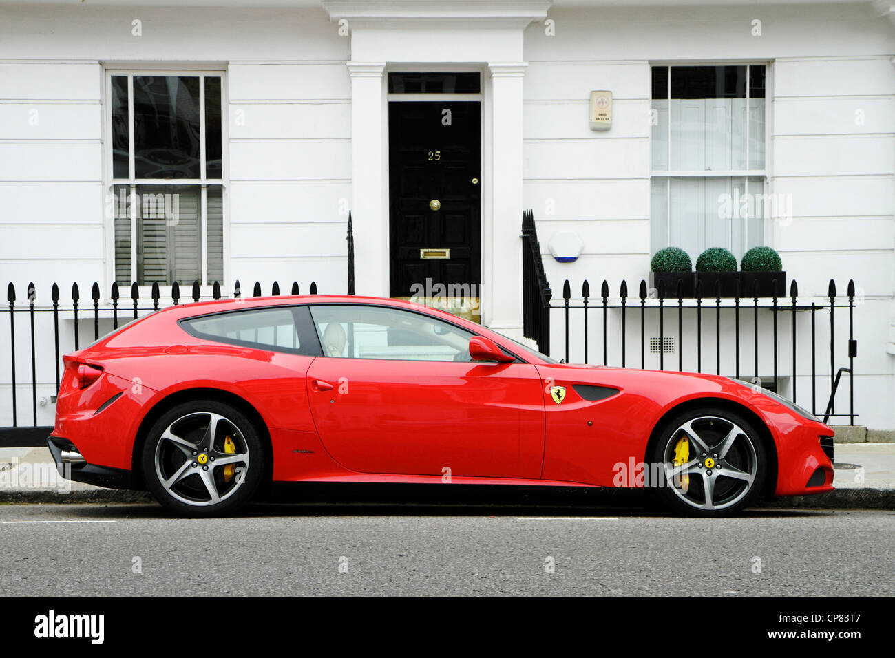 Red Ferrari FF sports car parked in affluent street, London borough of  Kensington and Chelsea, UK Stock Photo - Alamy